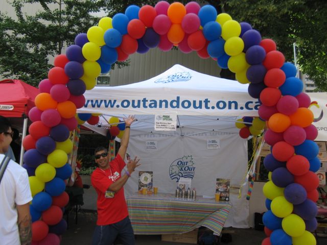 Out and Out's colourful balloon arch marking the entrance to their booth.