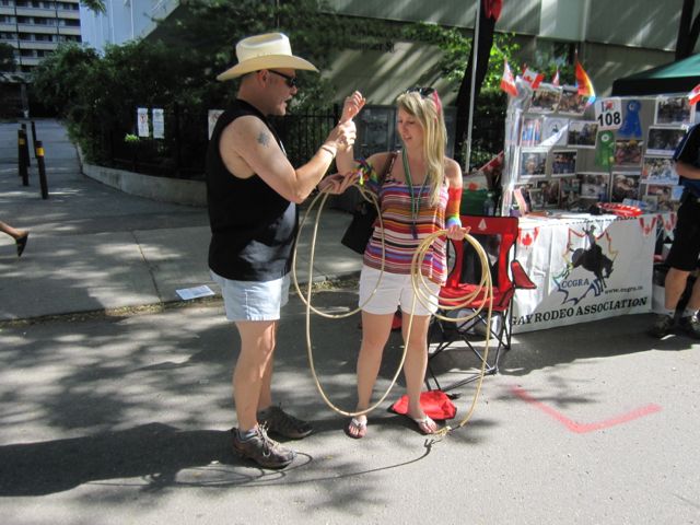 A passer-by learning a bit of roping technique at the CCGRA booth.